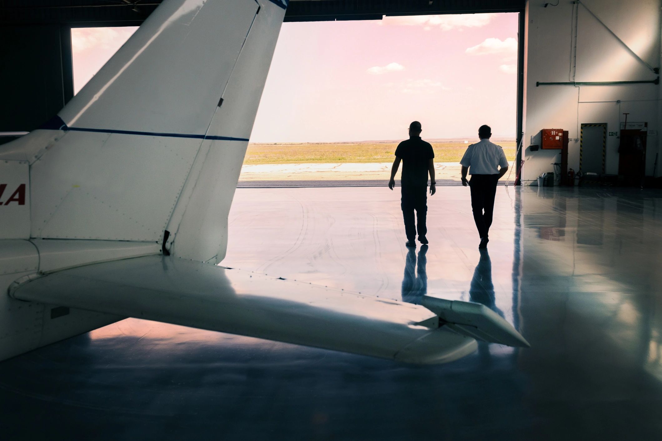 two pilots acrobatic biplane airport